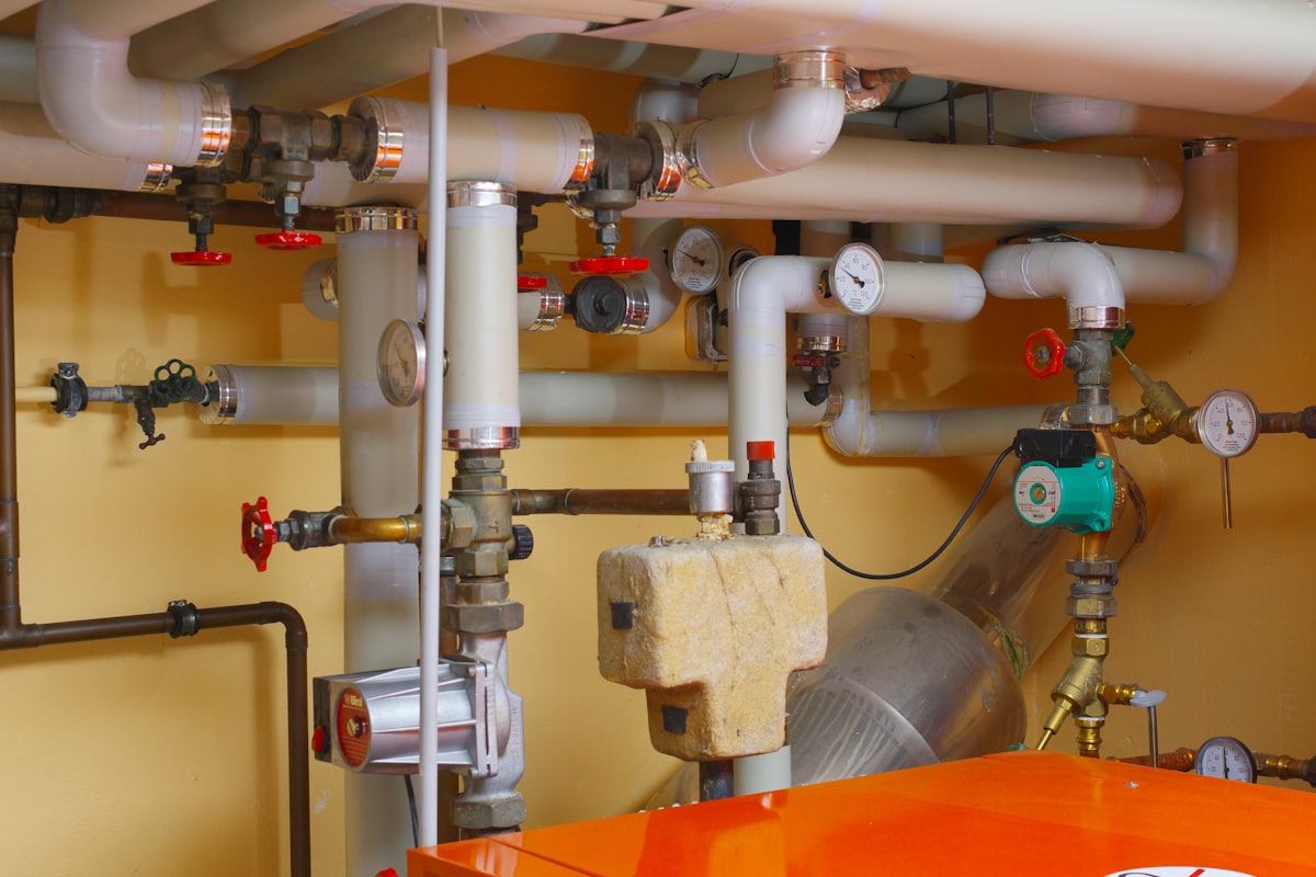 Heating pipework and valves above an orange boiler